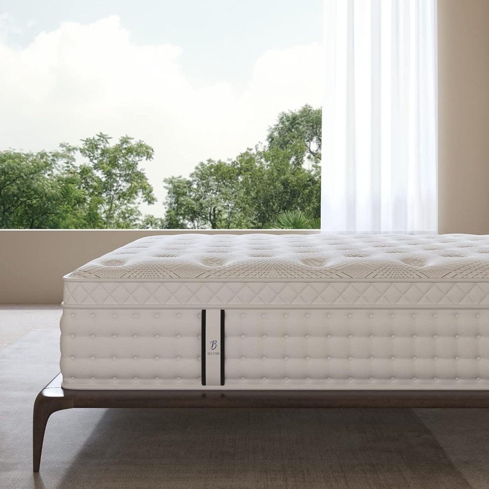 Bed with mattress against a bright window backdrop